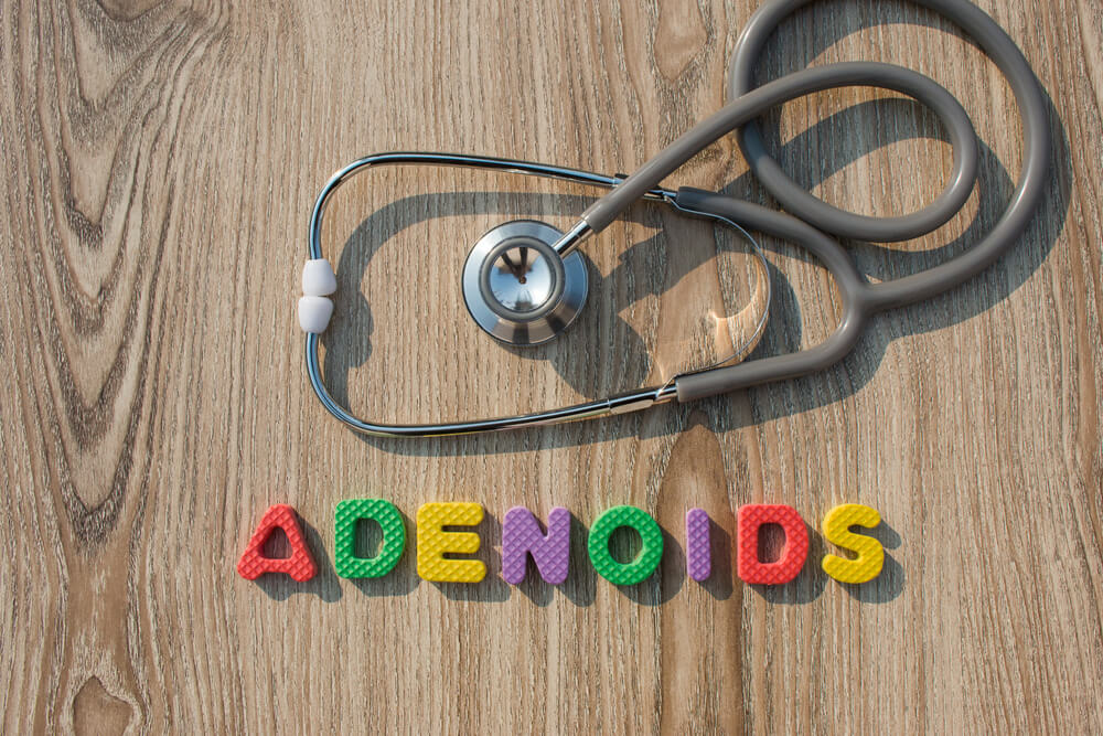 Adenoids colorful word on the wooden background with stethoscope